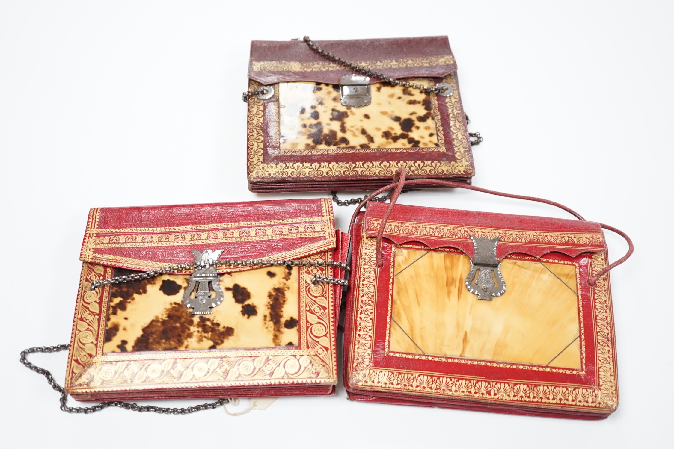 Three rare William IV red and burgundy tooled Moroccan leather and tortoiseshell panelled handbags, two with Scottish thistle shaped cut steel clasps